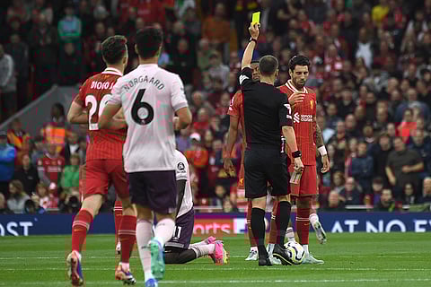 Premier League 2024-25: Referee Stuart Attwell shows a yellow card to Liverpool's Dominik Szoboszlai